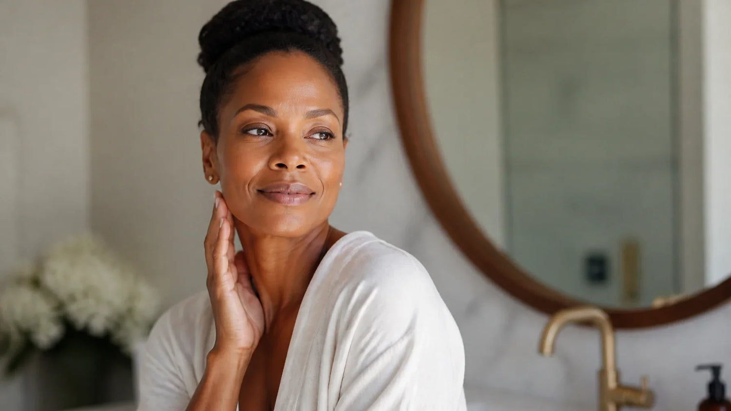 Radiant woman in her 40s with glowing skin enjoying a morning skincare ritual