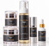 A five-piece skincare set from IKnow Cosmetics arranged on a reflective white surface. The set includes two stacked jars of night-time hydrating cream, a tall bottle of foaming face cleanser, a bottle of eye cream, and a dropper bottle of glow booster, all featuring black labels with gold lettering and dragonfly logos.
