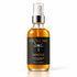 A bottle of IKnow Immerse pure neroli hydrosol aromatic facial mist, featuring amber liquid in a clear glass bottle with a black label and silver spray nozzle, set against a clean white background.