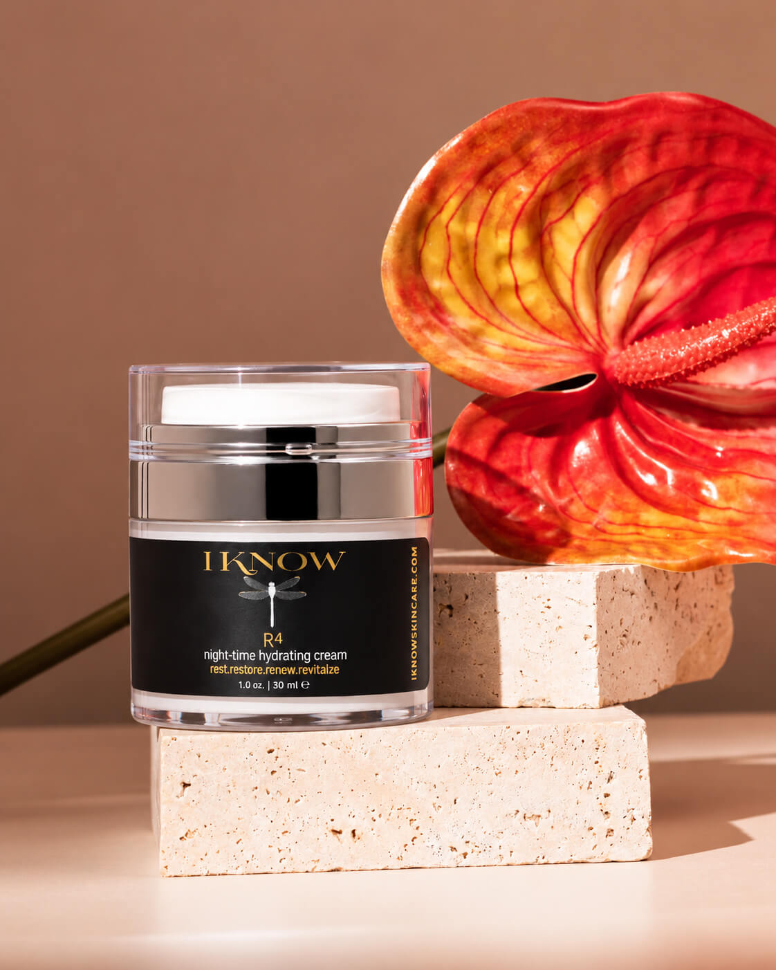 A clear cosmetic jar with a black label reading &
